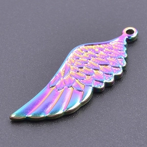 Macro detail of rainbow stainless steel feather pendant with iridescent plating texture