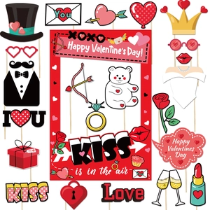 Set of Valentine's Day photo booth props including paper hats, hearts, and kiss signs