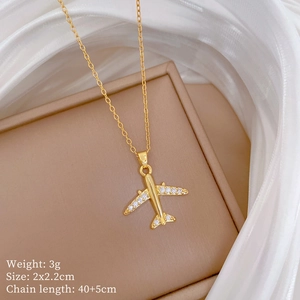Detail view of gold airplane pendant necklace with crystal inlay and size specifications