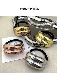 Detailed close-up of metallic pleated rings on black elastic hair ties in four elegant colors