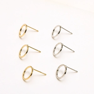 Macro view of 18k gold and silver plated C-shape open hoop earrings in a matrix layout