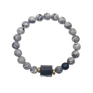 Detailed view of gray and black beaded bracelet with large rectangular stone and gold spacers