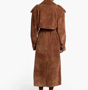 Back view of a long brown suede trench coat featuring a back flap and adjustable waist belt