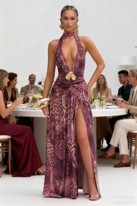 Detail of purple leopard print evening dress with gold floral waist and high slit