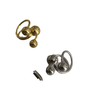 Modern triple-layered brass rings with three gold balls and sleek metallic finish