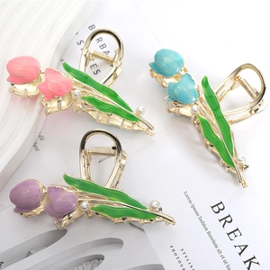 Detail of tulip hair clips in pink blue and purple with gold metal and pearls