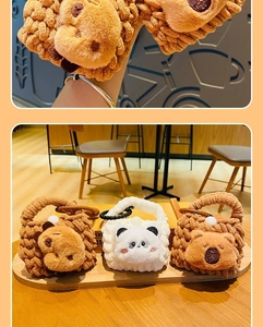 Close-up of handmade knitted animal earphone pouches featuring bear and panda designs