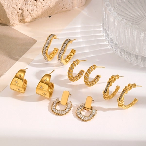 Golden C-shaped stainless steel earrings with star patterns and zircon stone details