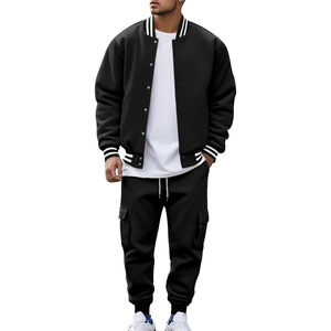 Detailed close-up of men's black varsity jacket set with white stripes and cargo joggers
