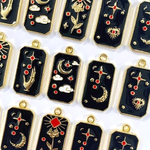 Star and moon tarot charm set in black enamel with gold alloy finish and red accents