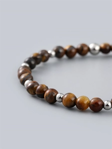 6mm tiger eye beaded bracelet for men with silver metal spacers on a grey background