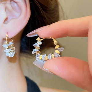 Macro detail of 18k gold plated geometric hoop earrings with clear crystal shards