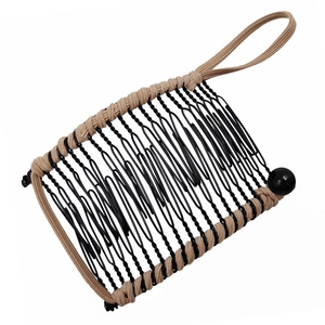 Black metal banana hair clip with beige woven fabric and beads on white background