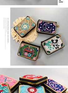 Detailed view of handmade bohemian beadwork and sequins embroidery on small zip coin purses