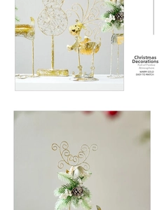 Detailed view of golden metal reindeer and pine cone decor on a sleek metal stand