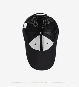 Detail view of the breathable mesh interior and washing label of the black baseball cap