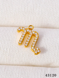 Macro shot of Scorpio zodiac pendant in gold finish with micro-pave cubic zirconia crystals