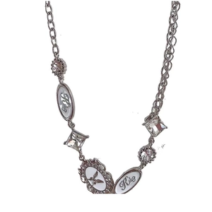 Macro detail of Y2K silver choker featuring white pendants with butterfly and Kity engraving