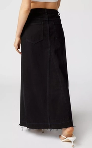 Rear view of long black denim skirt featuring back slit and raw distressed hem detail