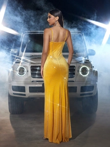 Detail of yellow velvet evening dress with sparkling rhinestones and slim fit silhouette