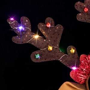 Detail of LED light string and colorful bells on glittering brown reindeer antlers