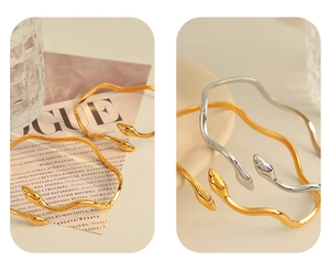 Macro detail of snake-inspired stainless steel bracelets in gold and silver finish