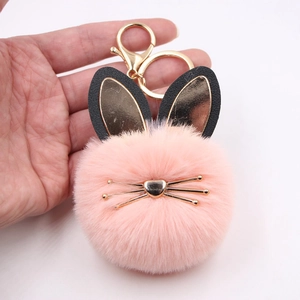 Pink faux fur pom-pom keychain with cute bunny ears and golden cat whiskers ornament