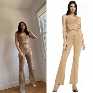 Detail of camel rib-knit two-piece set featuring side-tie camisole and drawstring trousers