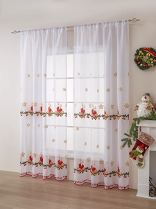 Detail of white semi-transparent Christmas curtain with red and green candle embroidery