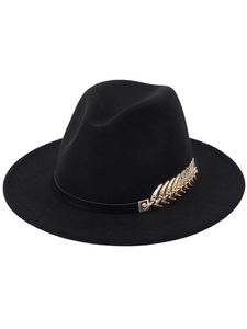 Detail of elegant black wool fedora featuring a stylish gold metal leaf accessory