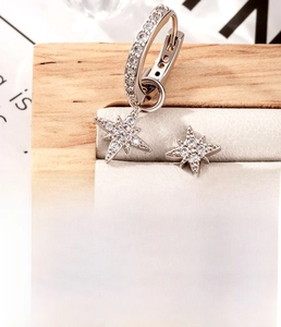 Detailed macro view of silver star stud earrings with zirconia inlays and titanium steel