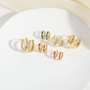 Set of six gold hoop earrings with colorful geometric cubic zirconia on silk fabric