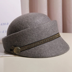 Detail of grey wool equestrian hat with braided band and vintage shell-shaped metal buckle