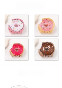 Detail of doughnut hair claw clips in cream, pink, red and chocolate brown colors