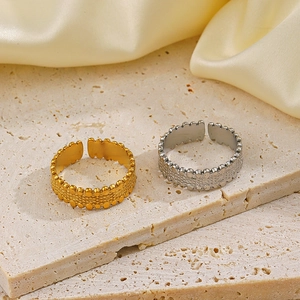 Adjustable stainless steel geometric rings in gold and silver with dotted texture finish