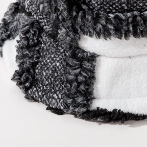 Close-up detail of plush black and white checkered wool texture on warm bucket hat