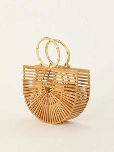 Detail view of the handmade woven bamboo handbag with hollow semi-circle design