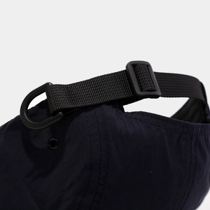Detail of navy quick-dry baseball cap featuring adjustable strap and plastic D-ring hook
