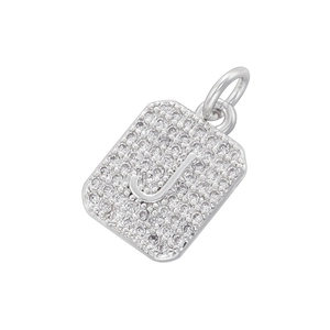 Macro view of silver rectangular pendant with pavé cubic zirconia and letter J detail
