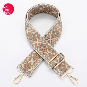 Detail of adjustable bohemian canvas bag strap with orange diamond pattern and gold hardware