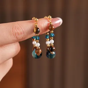 Retro tiger eye and pearl drop earrings featuring handmade beaded design and gold accents