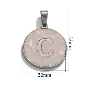 Macro detail of silver round letter C pendant with pink shell texture and 32mm size markings