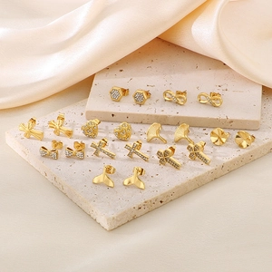 Detail of assorted gold-plated stainless steel stud earrings with shimmering rhinestones