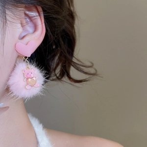 Close-up of pink flocking heart stud and plush ball with a cute golden bear pendant