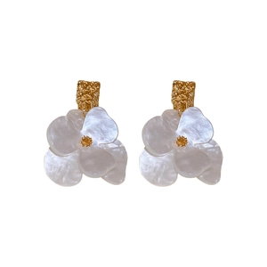 Vintage acrylic flower earrings with golden metal studs and pearly white petals