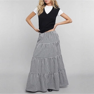Detail of black and white plaid tiered maxi skirt with elegant layered ruffles design