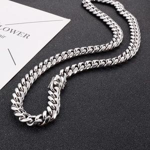 Detailed view of polished silver Cuban link chain featuring a secure square box clasp