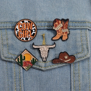 Set of 5 Western cowboy enamel pins with cow skull and boots on denim fabric