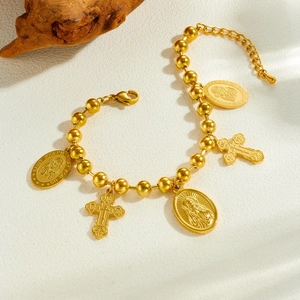Gold beaded chain bracelet with Saint Joseph religious medals and orthodox cross charm