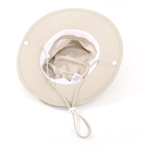 Detail of breathable mesh lining and adjustable chin strap on beige sun hat